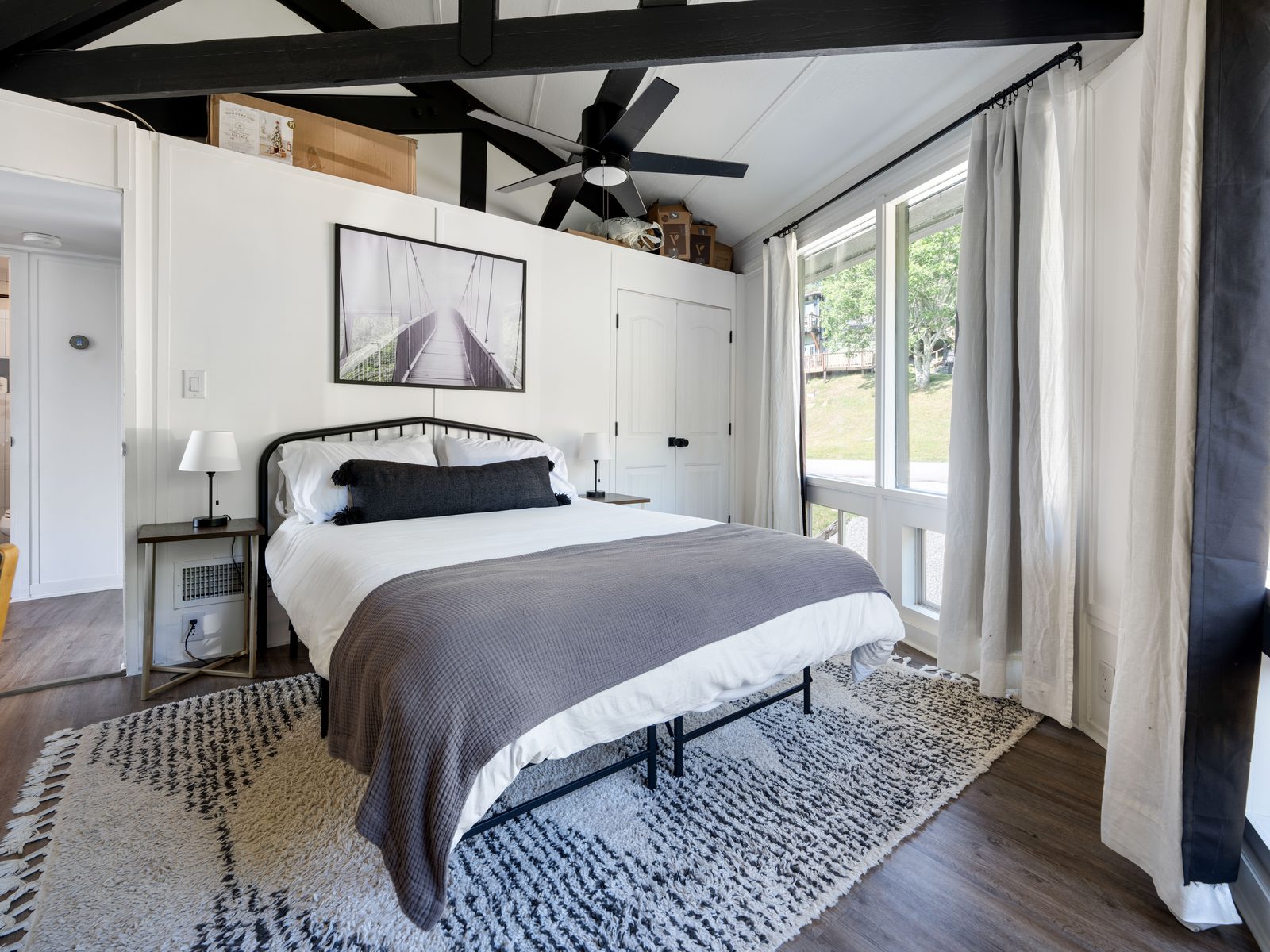 King bedroom with vaulted ceiling and artwork