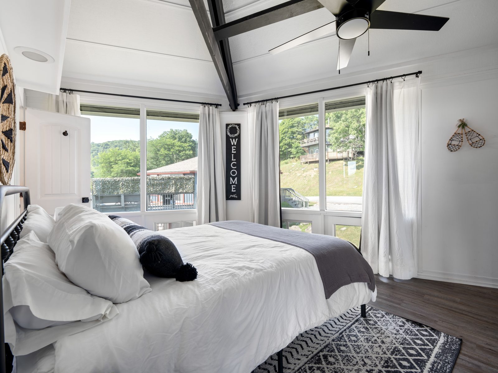 Queen bedroom with welcome sign and valley views