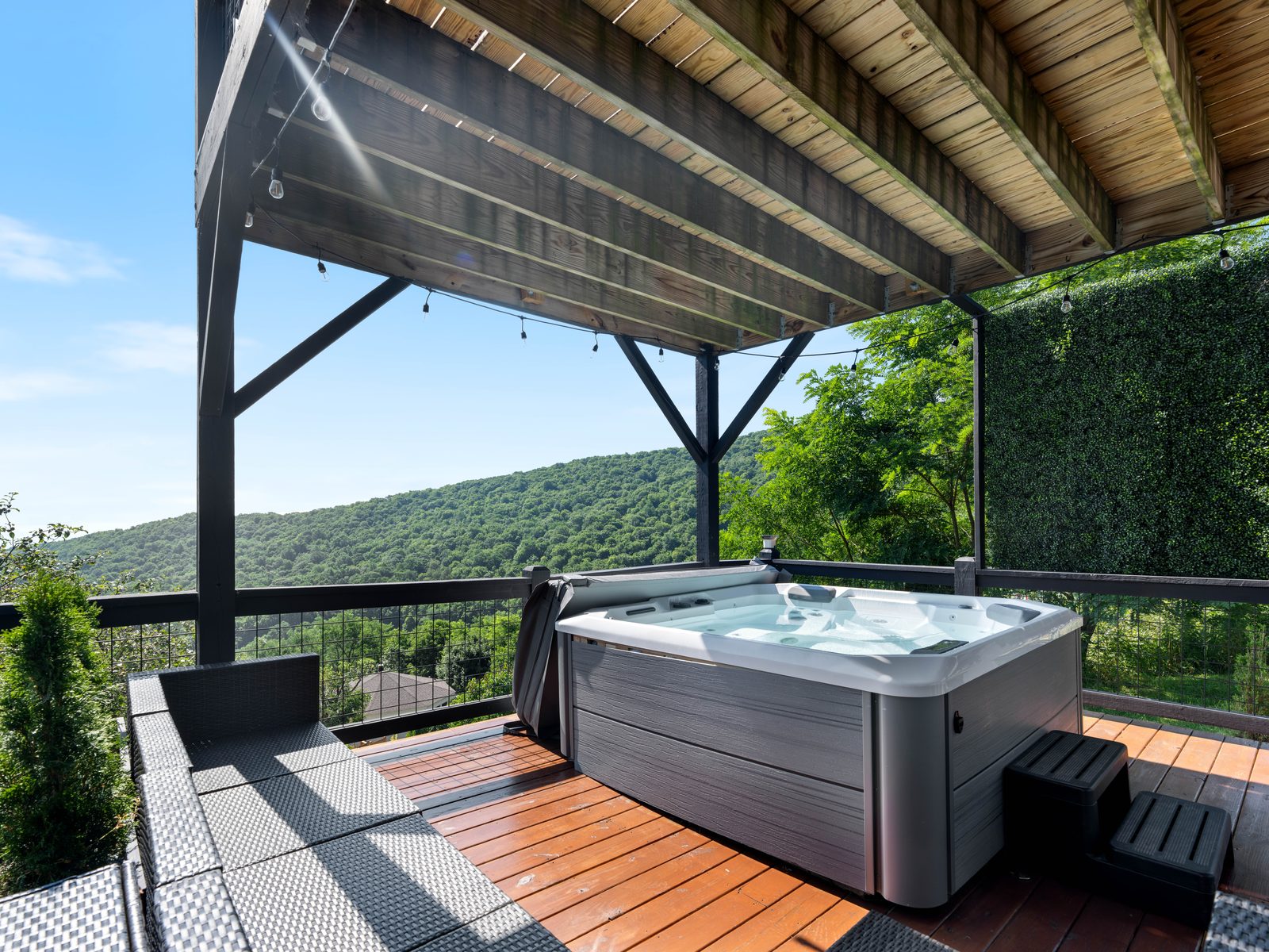 Hot tub with mountain views under a covered pergola